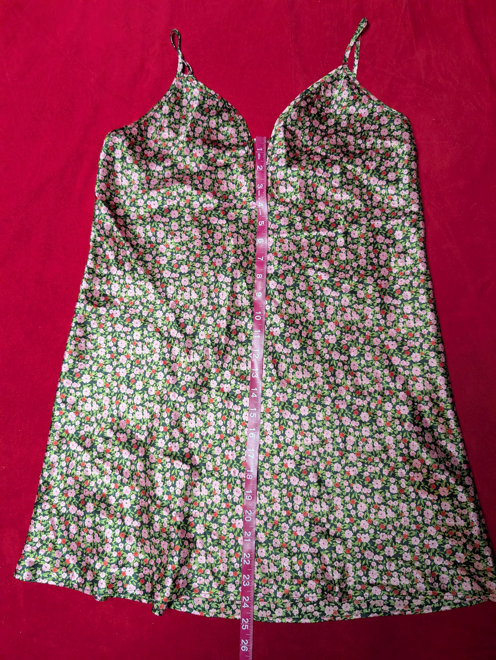 Floral dress with a measuring tape on a red background