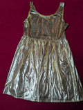 A shiny metallic gold sleeveless dress with a gathered waist, laid flat on a dark red background.